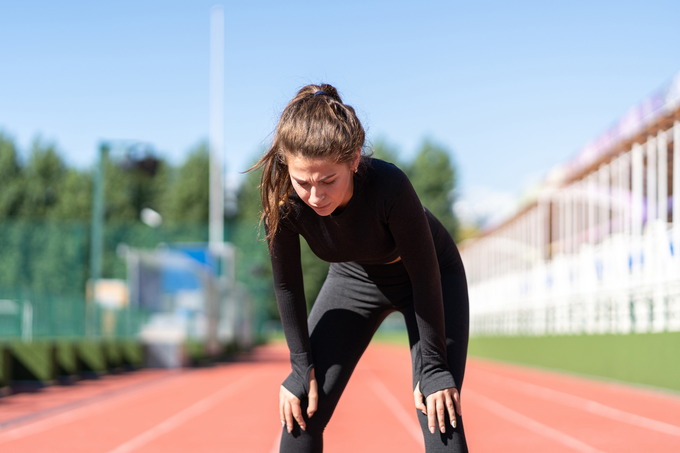 Woman in Sportswear on the Running Track